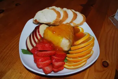 a plate of fruit and bread on a wooden table at Double Eagle Resort and Spa in June Lake