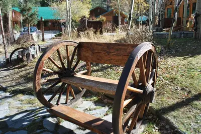 a wooden bench sitting on the grass in a park at Double Eagle Resort and Spa in June Lake