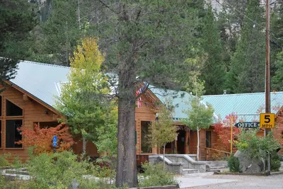 a log cabin with a sign in front of it at Double Eagle Resort and Spa in June Lake