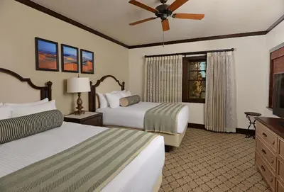 a hotel room with two beds and a flat screen tv at The Inn at Death Valley in Death Valley