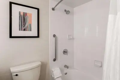 a white bathroom with a toilet and a shower at Hilton Garden Inn Reno in Reno