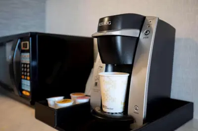 a coffee maker on a shelf next to a microwave at Hilton Garden Inn Reno in Reno