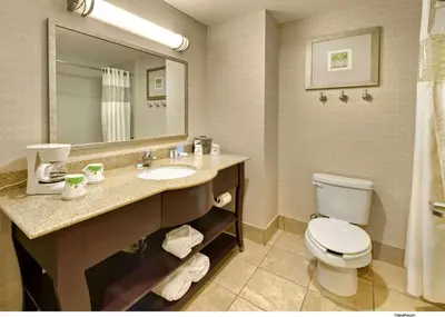 a bathroom with a sink and a toilet and a mirror at Hampton Inn & Suites Reno in Reno