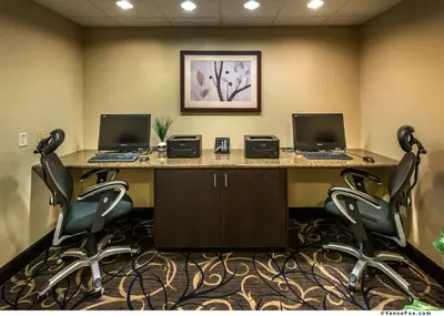 an office with two computers on a desk with chairs at Hampton Inn & Suites Reno in Reno