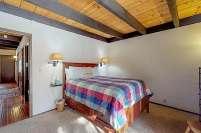 a bedroom with a bed and a wooden ceiling at Kingswood Retreat in Kings Beach