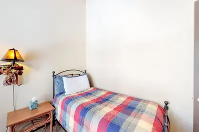 a bedroom with a bed and a table with a lamp at Kingswood Retreat in Kings Beach