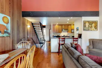 a living room and kitchen with a couch and a table at Kingswood Retreat in Kings Beach