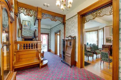 a living room with a staircase and a dining room at Lodi Hill House in Lodi