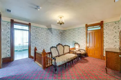 a living room with chairs and a table and window at Lodi Hill House in Lodi