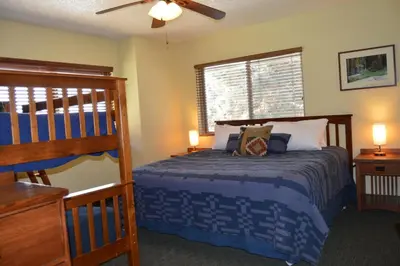a bedroom with a bed and a bunk bed at Montecito Sequoia Lodge in Sequoia National Park