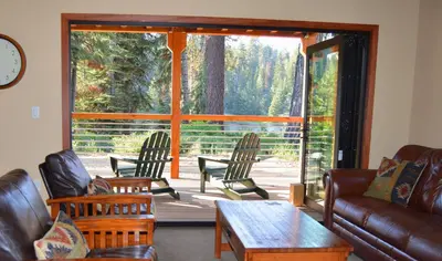a living room with a couch and chairs on a porch at Montecito Sequoia Lodge in Sequoia National Park
