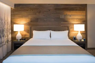 a bedroom with a bed and two lamps on tables at Hotel Azure in South Lake Tahoe