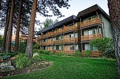 a large house with trees in front of it at Hotel Azure in South Lake Tahoe