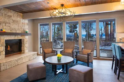 a living room with a fireplace and a table and chairs at Hotel Azure in South Lake Tahoe