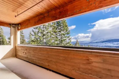 a room with a window with a view of the mountains at Bridges 107 in Mammoth Lakes