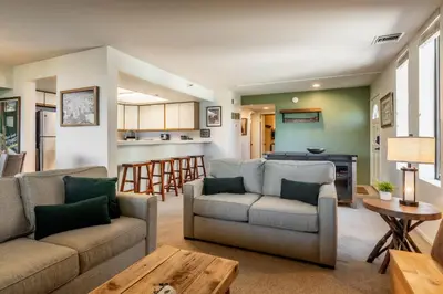 a living room with two couches and a kitchen at Bridges 107 in Mammoth Lakes