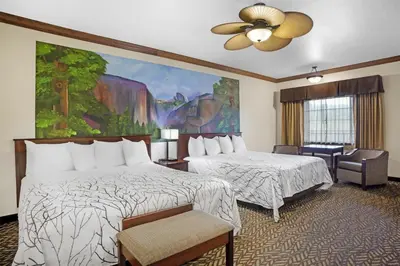 a hotel room with two beds and a ceiling fan at Best Western Plus Yosemite Gateway Inn in Oakhurst