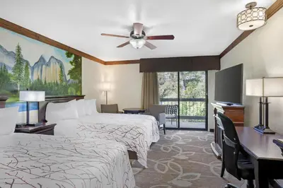 a hotel room with two beds and a window at Best Western Plus Yosemite Gateway Inn in Oakhurst