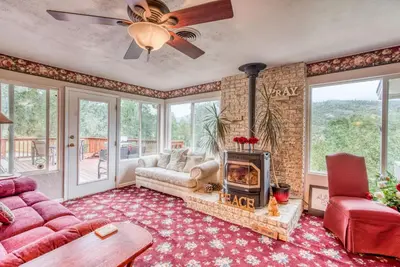 a living room with a couch and a fireplace at A Bed of Roses in Yosemite Forks