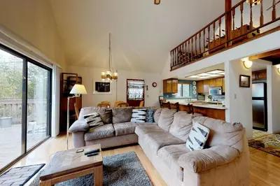 a living room with a couch and a table at Cozy Chalet (15-013) in Groveland