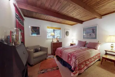 a bedroom with a bed and a chair at Cozy Chalet (15-013) in Groveland