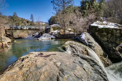 a bridge over a river with a waterfall at Lake Lodge Beach (04-040) in Groveland
