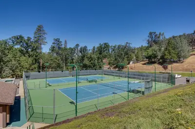 a tennis court on a hill with two tennis courts at Lake Lodge Beach (04-040) in Groveland