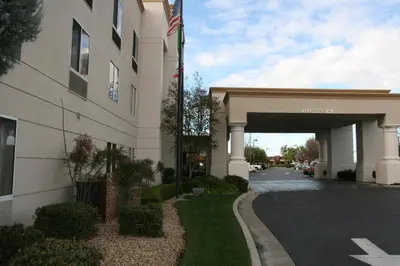 a building with an american flag next to a street at Holiday Inn Express Stockton Southeast by IHG in Stockton