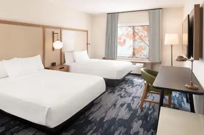 a hotel room with two beds and a desk at Fairfield Inn & Suites by Marriott Fresno North/Shaw Avenue in Fresno