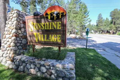 a sign for a sunshine village on a street at Sunshine Village 104 Condo in Mammoth Lakes