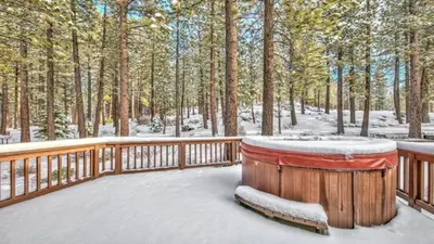 a large wooden deck with snow on it at Your Roomy Northstar Retreat Awaits in Truckee