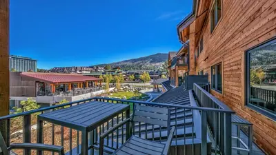 a balcony with blue tables and chairs on a building at Luxury 3Br Residence Steps From Heavenly Village & Gondola Condo in South Lake Tahoe