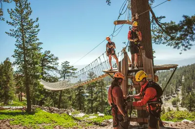 a group of people on a zip line in the trees at Luxury Three Bedroom Residence Steps From Heavenly Village Condo in South Lake Tahoe