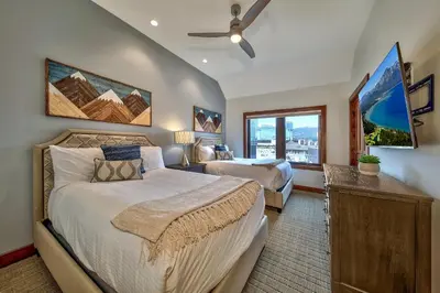 a bedroom with two beds and a window at Luxury Three Bedroom Residence Steps From Heavenly Village Condo in South Lake Tahoe