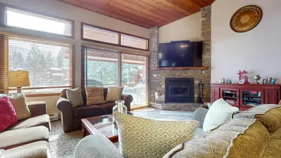 a living room with a couch and a fireplace at Woodlands #33 Condo in Mammoth Lakes
