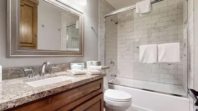 a bathroom with a sink and a toilet and a tub at Woodlands #33 Condo in Mammoth Lakes