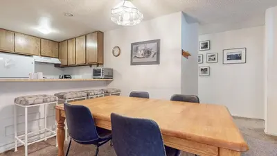 a dining room with a wooden table and chairs at Summit Condominium #273 Condo in Mammoth Lakes