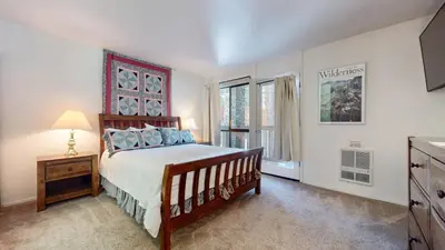 a bedroom with a bed and a large window at Summit Condominium #273 Condo in Mammoth Lakes
