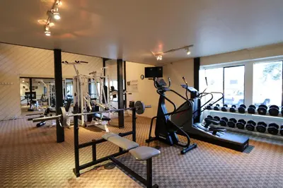 a gym with treadmills and exercise bikes in a room at Summit Condominium #267 Condo in Mammoth Lakes