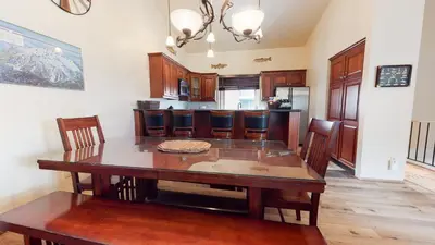 a kitchen with a wooden table and a dining room at Helios North #5 Condo in Mammoth Lakes