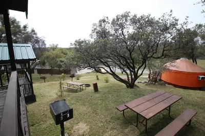 a tent and a picnic table in a field at Yosemite RV Resort in Coarsegold