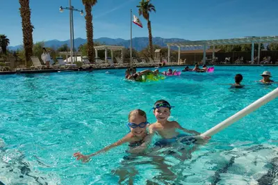 two boys in the swimming pool at a resort at The Ranch At Death Valley in Death Valley