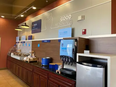 a coffee shop with a counter with aperature at Holiday Inn Express Oakdale by IHG in Oakdale