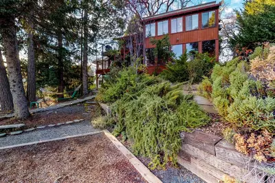 a house with trees and plants in front of it at Heart's Desire on the Lake (01-275) in Groveland