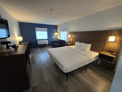 a hotel room with a large bed and a television at Quality Inn & Suites Tulare in Tulare