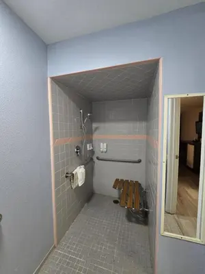 a bathroom with a shower and a toilet in a room at Quality Inn & Suites Tulare in Tulare