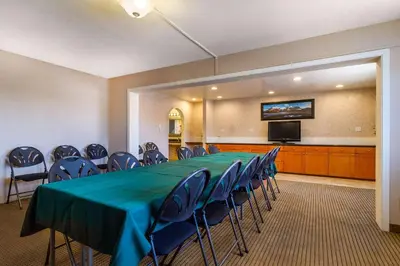 a conference room with a long table and chairs at Auburn House Hotel in Auburn