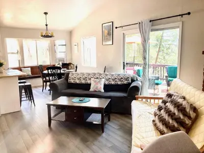 a living room with a couch and a table at NEW! Cozy & Secluded House w/Deck - Near Yosemite! in Tuolumne