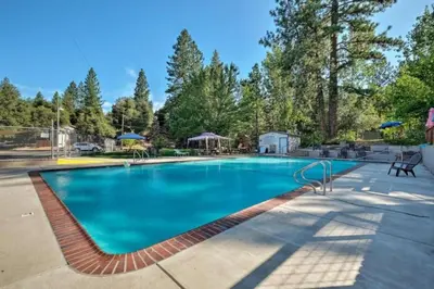 a large swimming pool with blue water at NEW! Cozy & Secluded House w/Deck - Near Yosemite! in Tuolumne