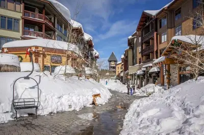 a street covered in snow next to buildings at Mammoth View Villas 21 in Mammoth Lakes